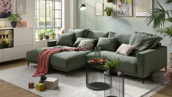 Ein grünes Familienecksofa mit Cordbezug.